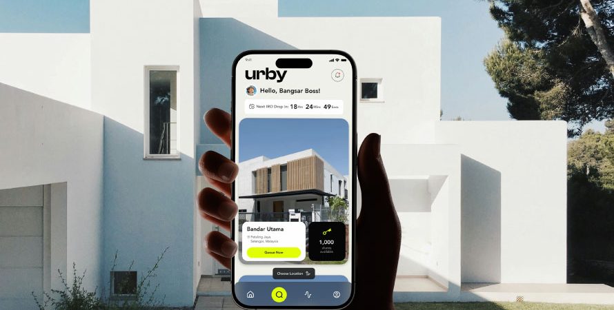 A user holding a mobile phone, interacts with the Urby property app that showcases a modern mobile UI designed by Bike Bear, a top web design agency in Malaysia.