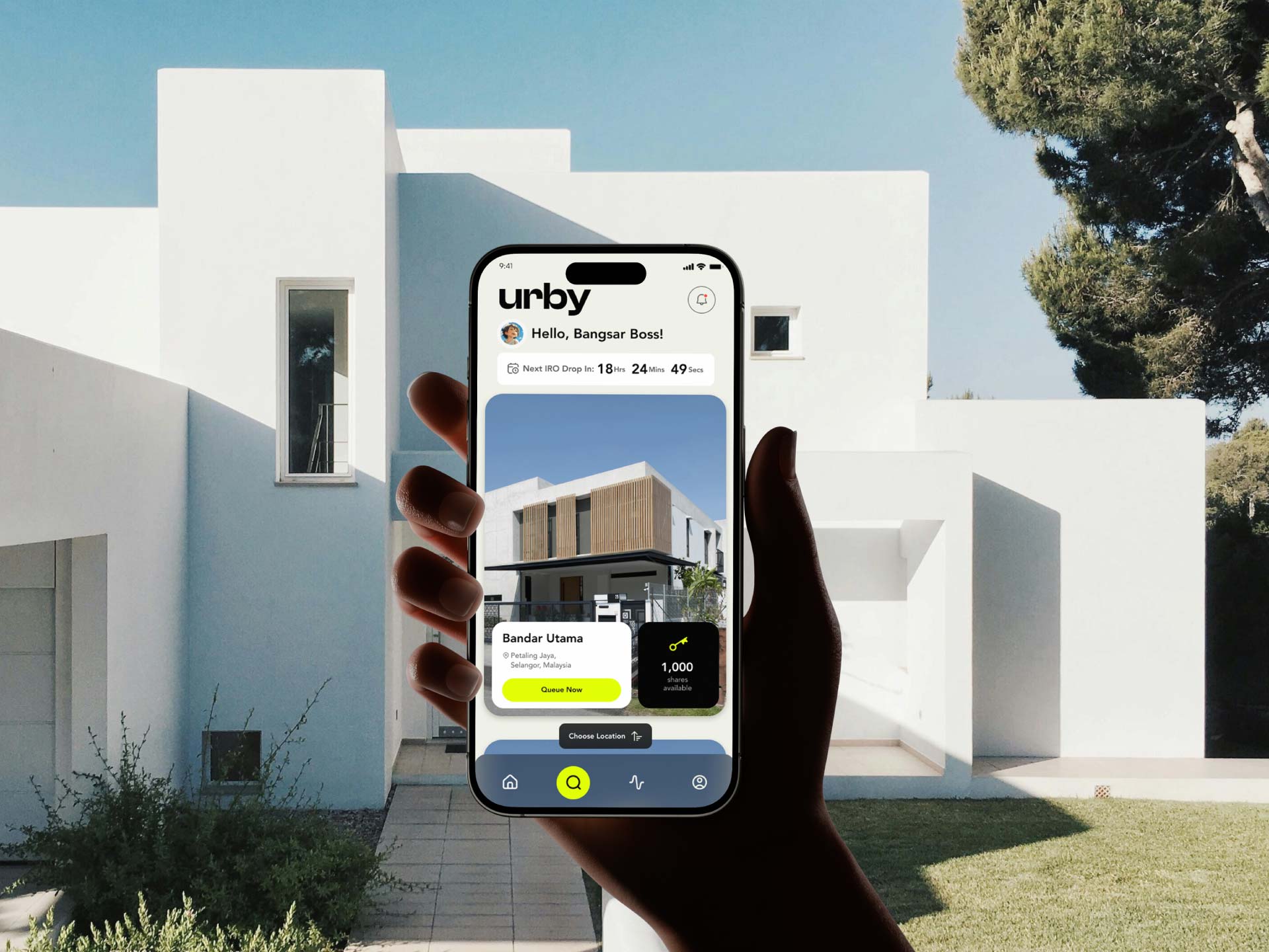 A user holding a mobile phone, interacts with the Urby property app that showcases a modern mobile UI designed by Bike Bear, a top web design agency in Malaysia.